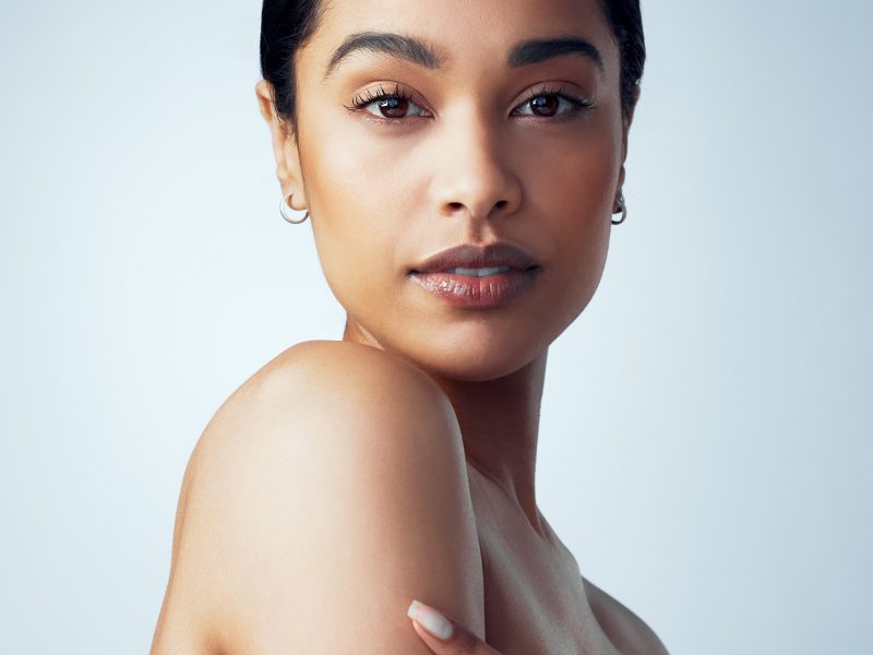 Skincare, makeup and portrait of woman isolated on a white background for skin glow, shine and beauty for luxury. Face of young model or biracial person, natural cosmetics or dermatology in studio.